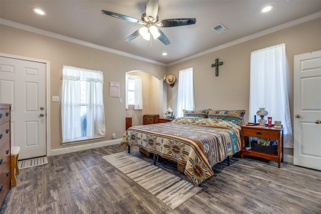 bedroom with crown molding, ceiling fan, and dark wood-type flooring