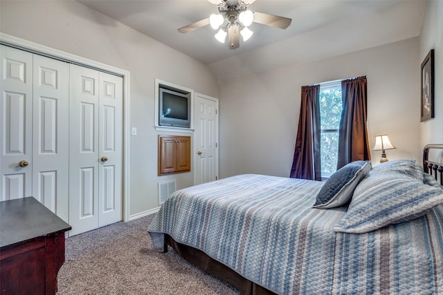 carpeted bedroom featuring a closet, vaulted ceiling, and ceiling fan