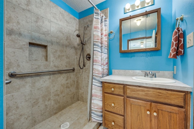 bathroom featuring a shower with curtain, a textured ceiling, and vanity