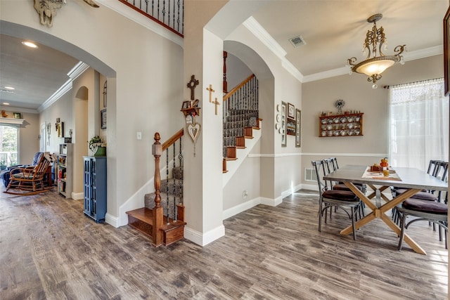 dining room featuring crown molding and dark wood-type flooring