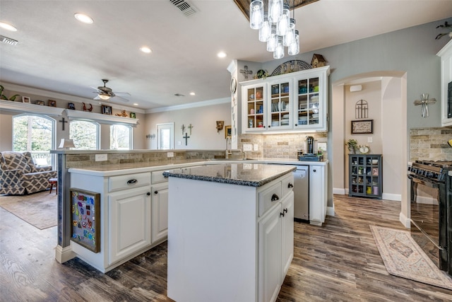 kitchen featuring kitchen peninsula, a kitchen island, black range, and sink