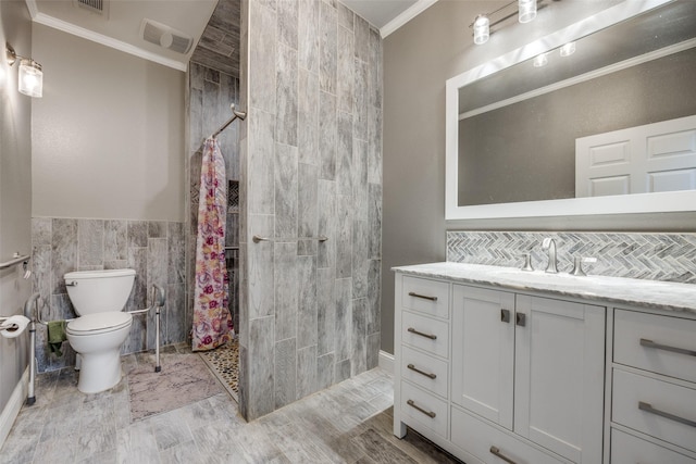 bathroom featuring a shower with shower curtain, vanity, crown molding, tile walls, and toilet