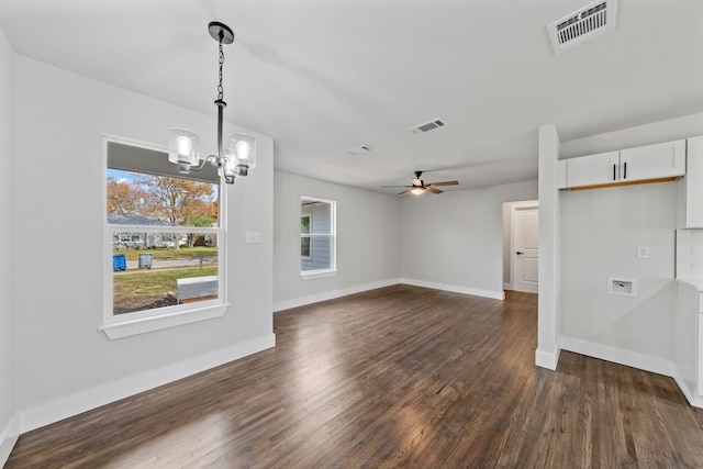 unfurnished living room featuring dark wood-type flooring and ceiling fan with notable chandelier