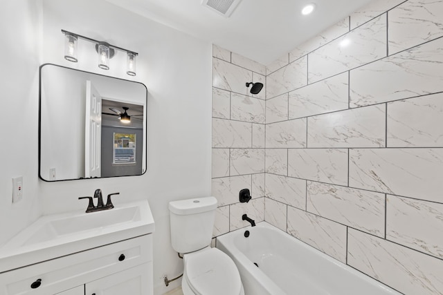 full bathroom featuring tiled shower / bath combo, ceiling fan, toilet, and vanity