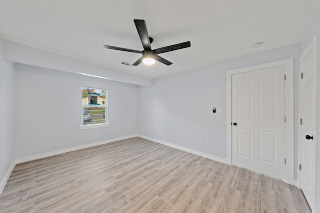 empty room featuring light wood-type flooring and ceiling fan