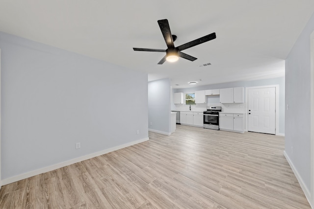 unfurnished living room featuring ceiling fan and light hardwood / wood-style flooring