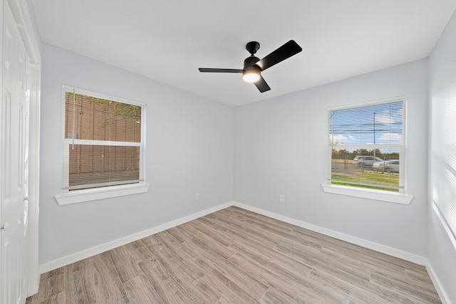 unfurnished room with ceiling fan and light wood-type flooring