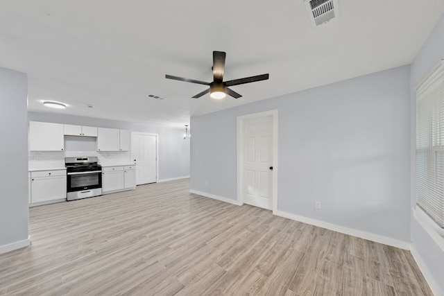 kitchen featuring ceiling fan, stainless steel range, white cabinets, and light hardwood / wood-style floors