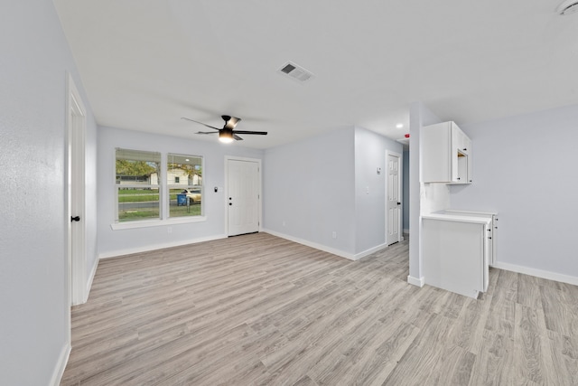 unfurnished living room featuring light hardwood / wood-style flooring and ceiling fan