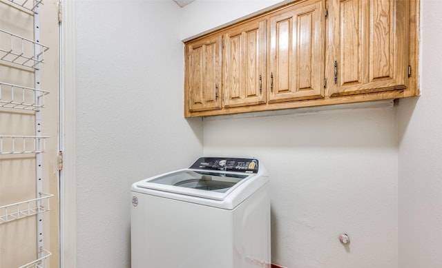 laundry area with washer / clothes dryer and cabinets