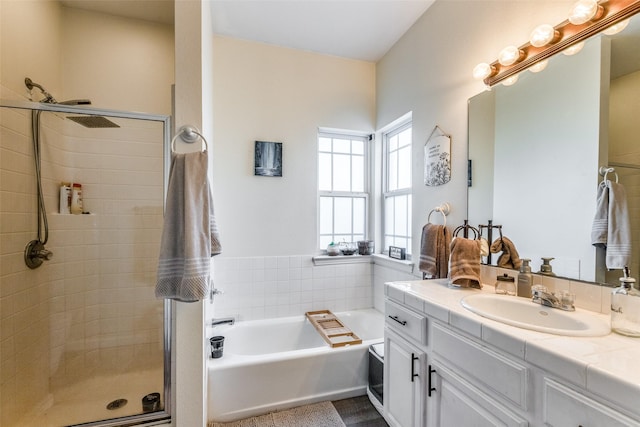 bathroom featuring vanity and independent shower and bath