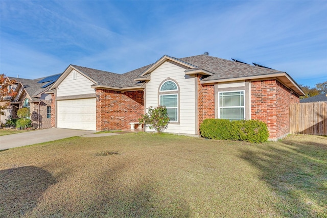 view of front of house featuring a garage and a front lawn