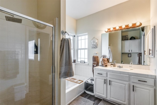 bathroom with hardwood / wood-style flooring, vanity, and independent shower and bath