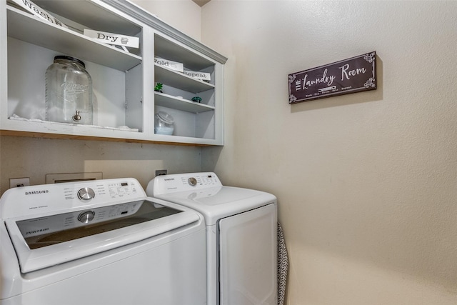 washroom with washing machine and clothes dryer