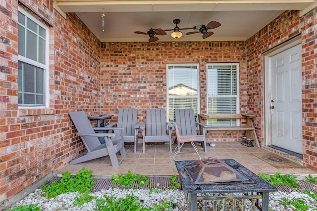 view of patio featuring ceiling fan and an outdoor fire pit