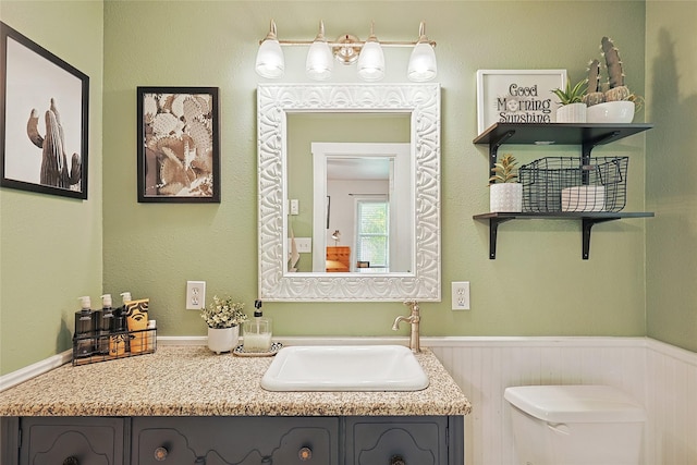 bathroom featuring vanity and toilet