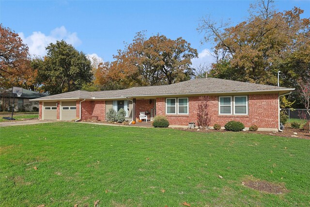 ranch-style house with a front lawn and a garage