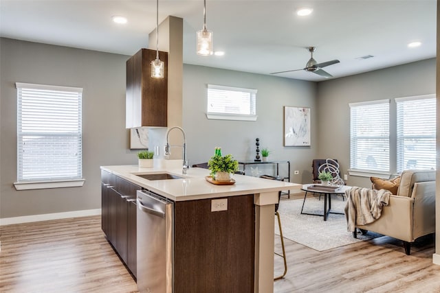 kitchen featuring a wealth of natural light, light hardwood / wood-style floors, and hanging light fixtures