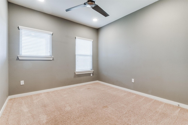 empty room featuring carpet flooring, ceiling fan, and plenty of natural light