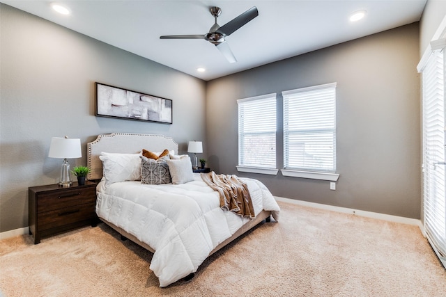 bedroom featuring light carpet and ceiling fan