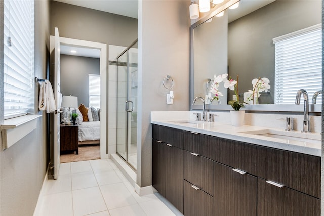 bathroom with tile patterned flooring, vanity, and a shower with shower door