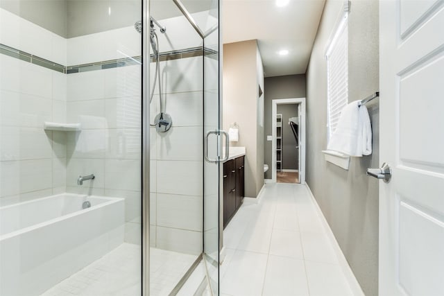 full bathroom featuring vanity, tile patterned flooring, plus walk in shower, and toilet