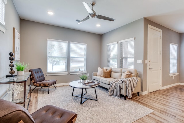 living room featuring ceiling fan and light wood-type flooring