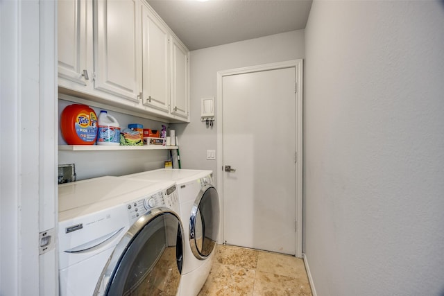 laundry area featuring cabinets and washing machine and dryer