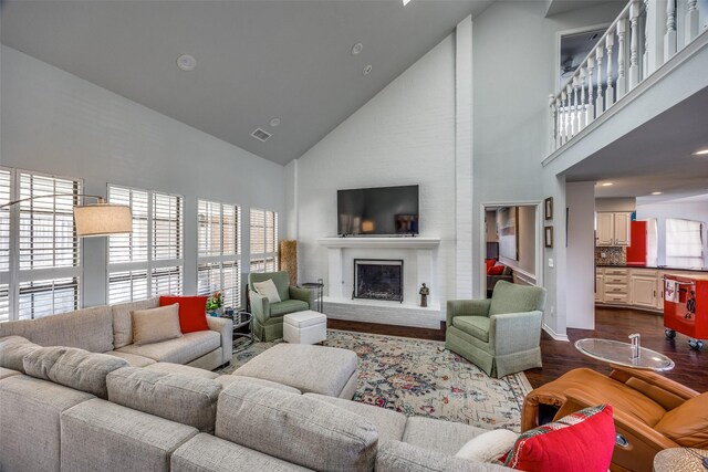 living room featuring high vaulted ceiling and dark wood-type flooring