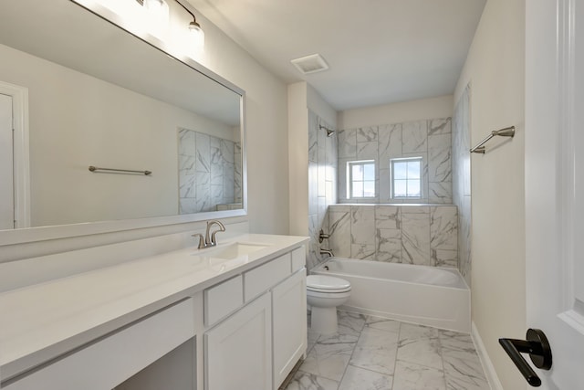 full bathroom with toilet, vanity, and tiled shower / bath