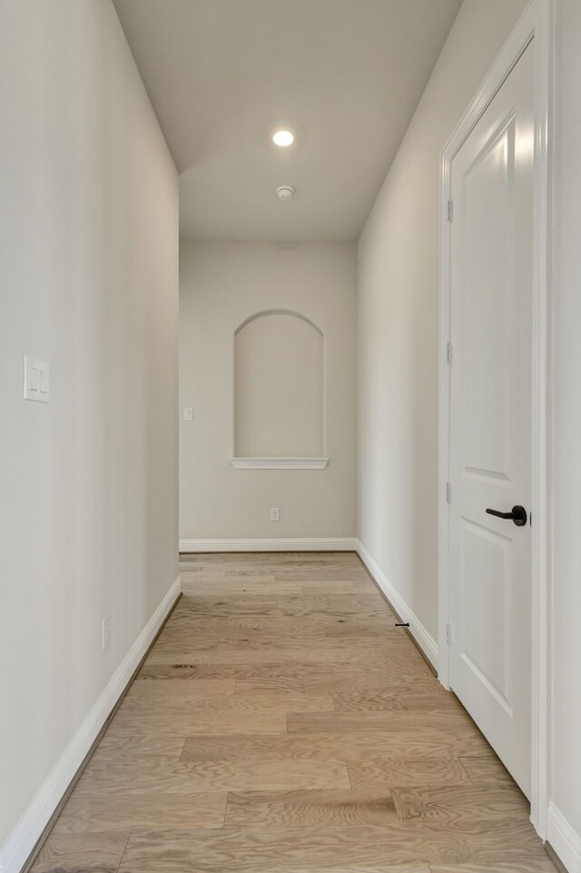 corridor with light hardwood / wood-style floors