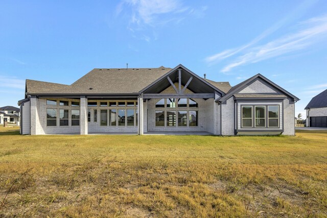 rear view of property with a lawn