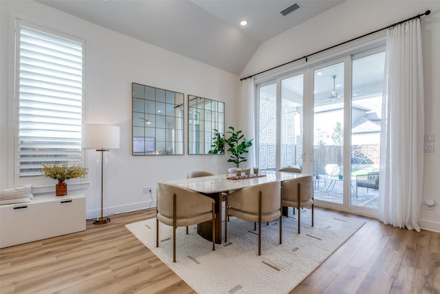 dining room featuring ceiling fan, light hardwood / wood-style floors, and lofted ceiling