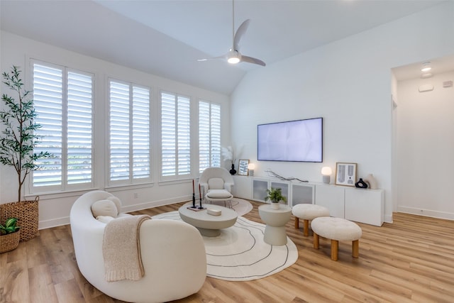 sitting room featuring light hardwood / wood-style floors, a healthy amount of sunlight, and lofted ceiling