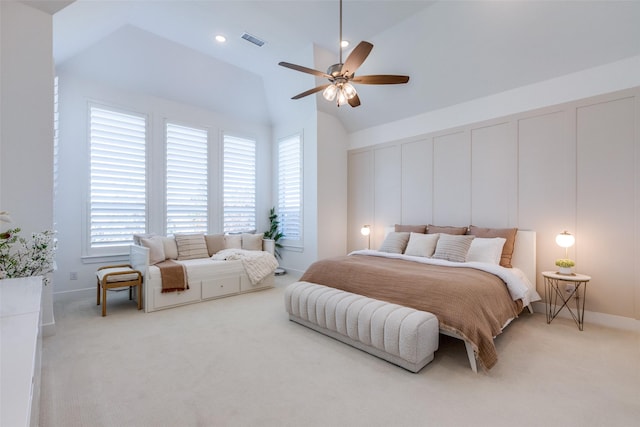 bedroom with multiple windows, ceiling fan, light colored carpet, and lofted ceiling