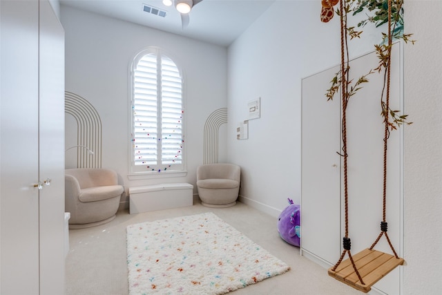 sitting room featuring carpet flooring and plenty of natural light