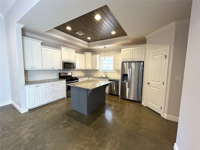 kitchen featuring white cabinetry, appliances with stainless steel finishes, a raised ceiling, and hanging light fixtures