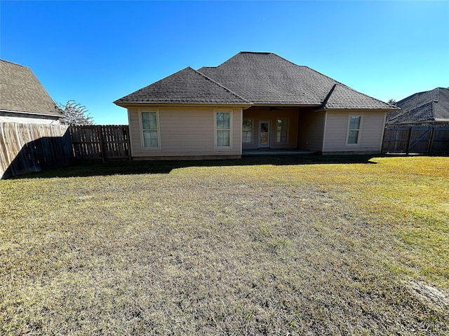 back of property featuring a yard