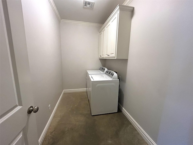 laundry room featuring cabinets, crown molding, and washer and dryer