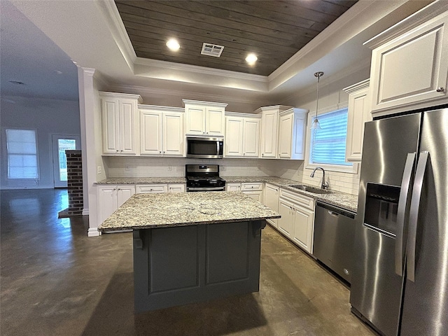 kitchen with pendant lighting, a raised ceiling, sink, a center island, and stainless steel appliances