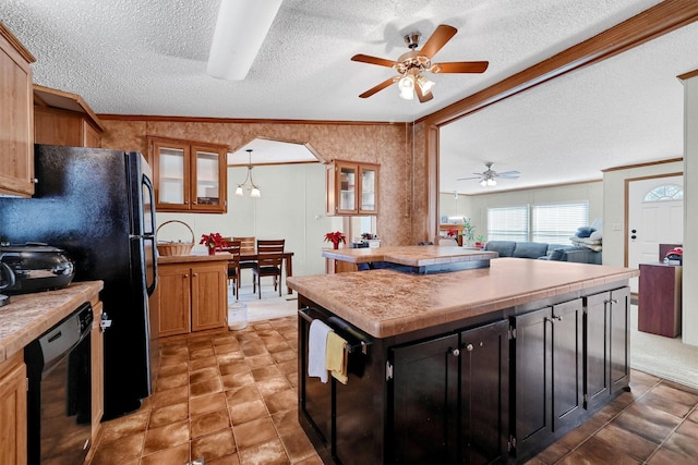 kitchen with black appliances, hanging light fixtures, ceiling fan, a textured ceiling, and a kitchen island