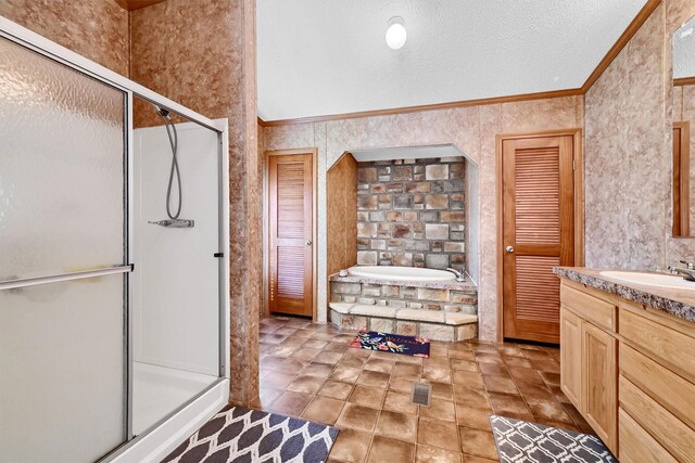 bathroom with a textured ceiling, vanity, separate shower and tub, and crown molding