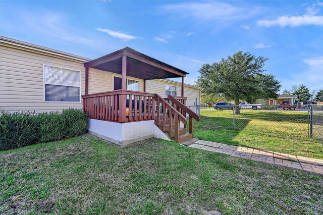 exterior space featuring a yard and a wooden deck