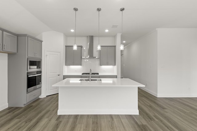216 Hope Orchards, Lavon, TX 75166 - kitchen featuring gray cabinetry, wall chimney range hood, stainless steel oven, light countertops, and wood finished floors