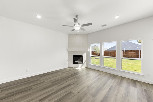 216 Hope Orchards, Lavon, TX 75166 - unfurnished living room featuring ceiling fan, wood finished floors, baseboards, a tiled fireplace, and recessed lighting