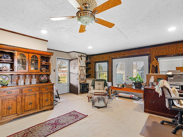 carpeted office featuring crown molding, ceiling fan, and a textured ceiling