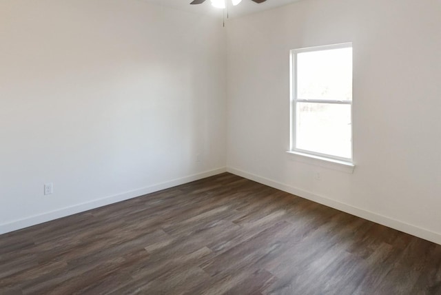 empty room featuring ceiling fan and dark wood-type flooring