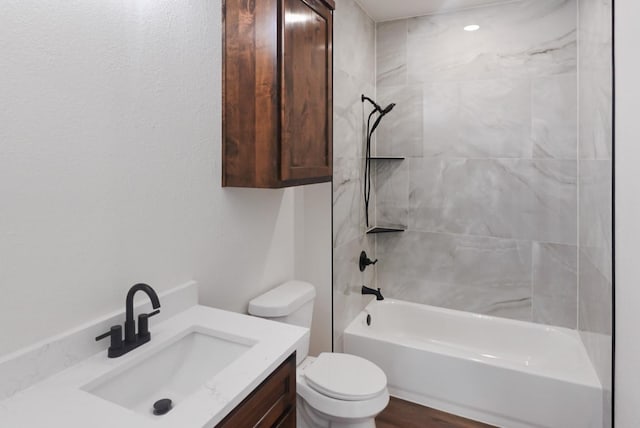 full bathroom featuring vanity, toilet, and tiled shower / bath