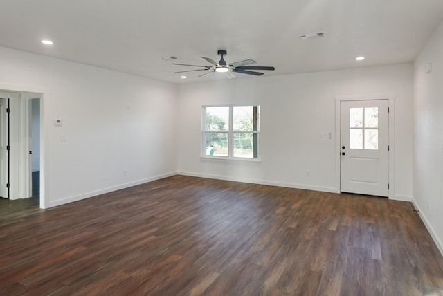 unfurnished living room featuring dark hardwood / wood-style flooring and ceiling fan