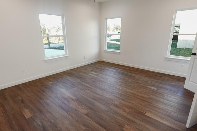 spare room with dark wood-type flooring